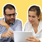 A lawyer and staff member reviewing law firm blog ideas on a tablet
