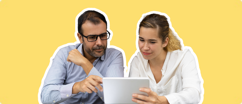 A lawyer and staff member reviewing law firm blog ideas on a tablet