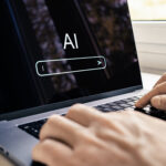 Man typing on a computer with AI chatbot on the laptop screen