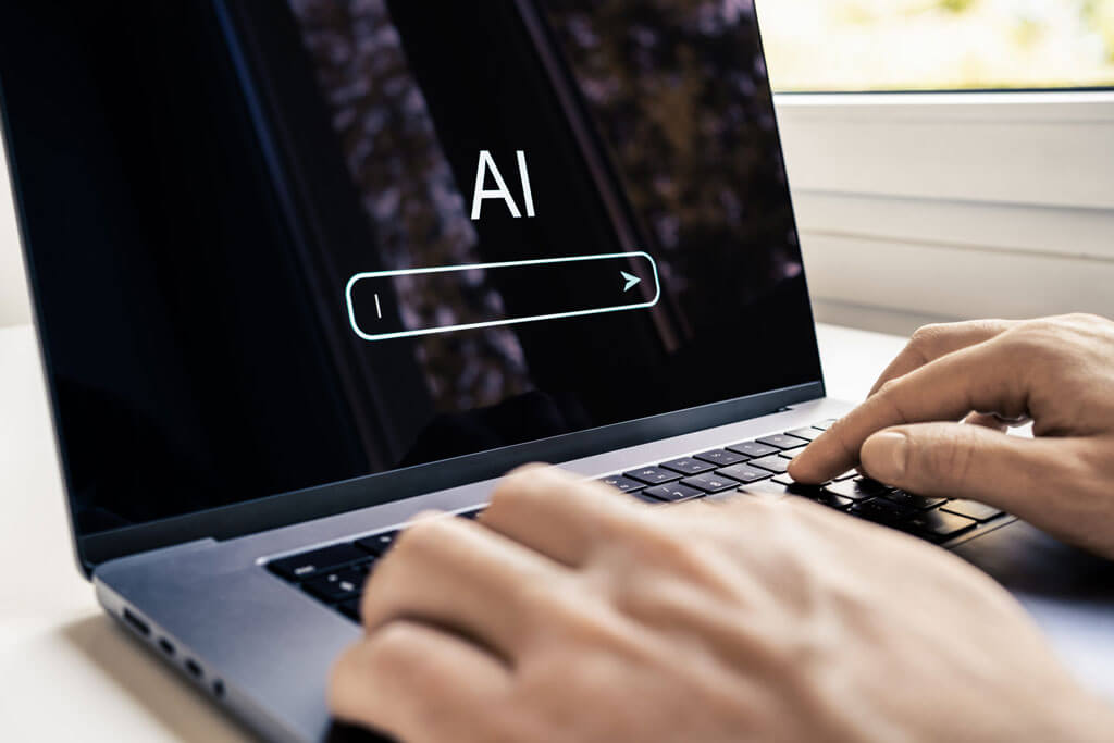Man typing on a computer with AI chatbot on the laptop screen